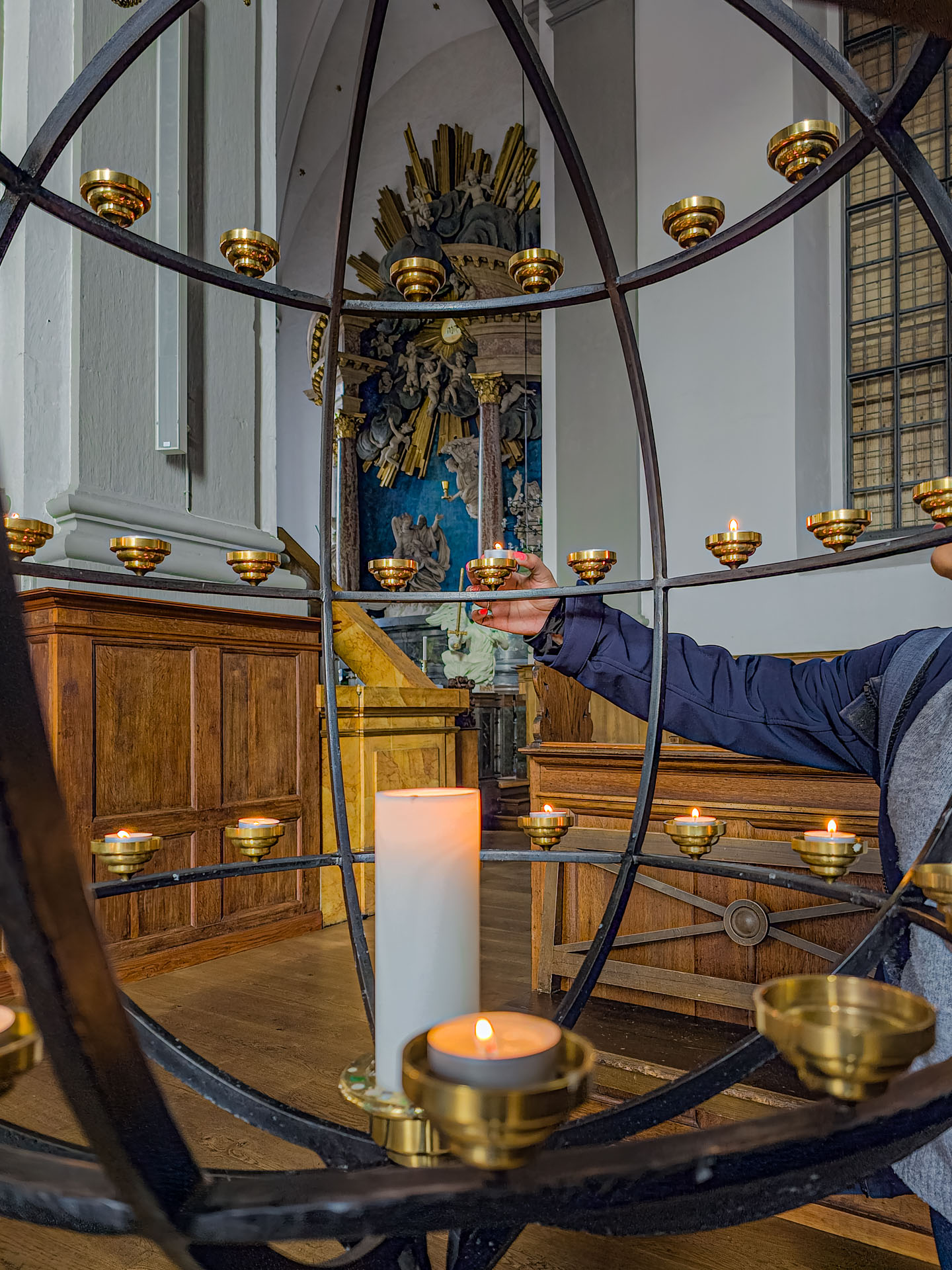Lighting candles inside Church of Our Saviour Copenhagen